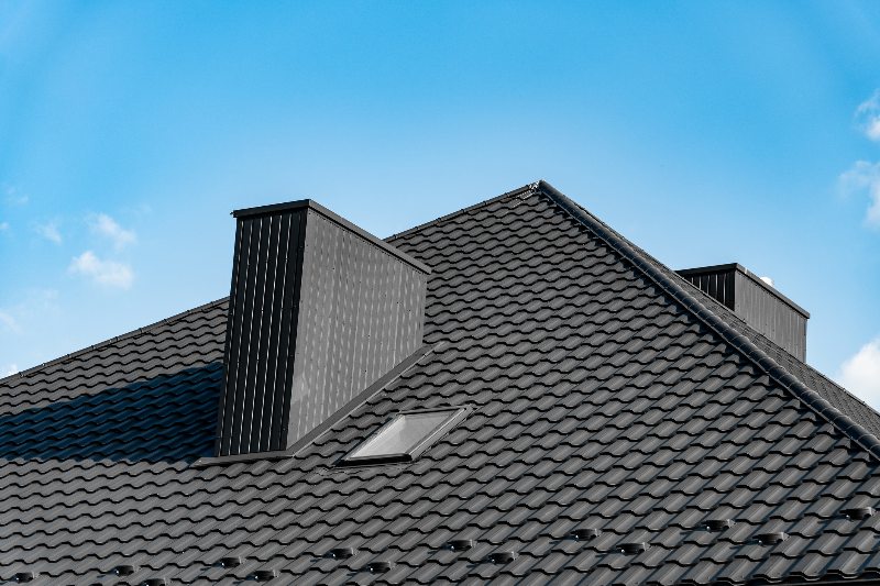 An energy-efficient roof by a blue sky by NorCal Roofing & Gutters