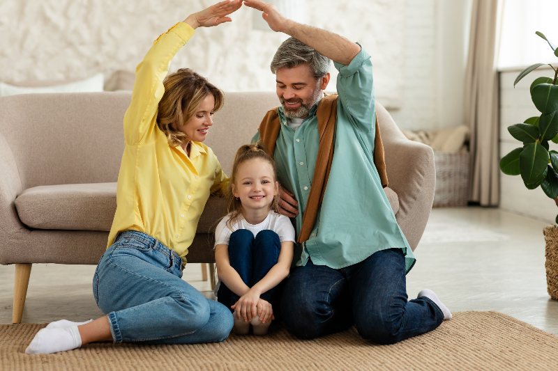 A family holding their arms up in protection by NorCal Roofing & Gutters