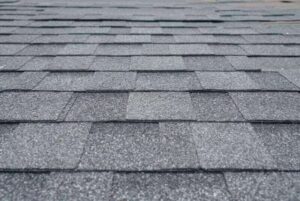 A close-up of grey shingles on a house by NorCal Roofing & Gutters