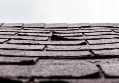 A close-up of roofing shingles that are separating from a roof by NorCal Roofing & Gutters
