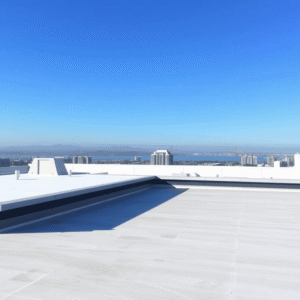 Rooftop of a modern commercial building with sleek roofing materials, clear blue sky, and the San Francisco Bay Area skyline faintly visible in the...