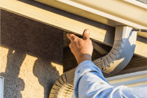 A Technician at a Residential House Performing Gutter Repair Services in Sacramento, CA